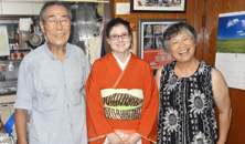 Trying on a kimono (traditional Japanese clothing) with her host parents.